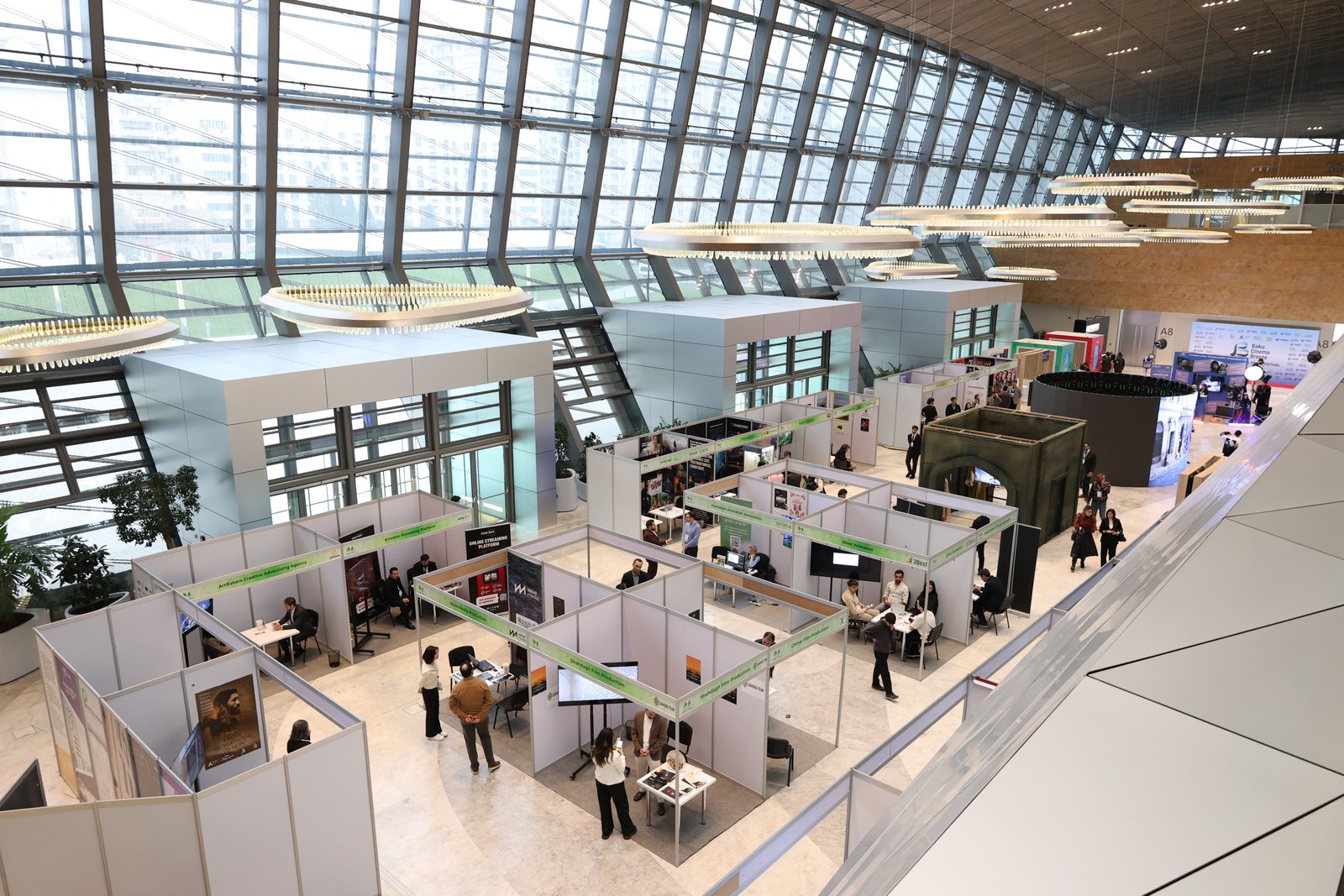 Exhibition floor with visitors browsing booths